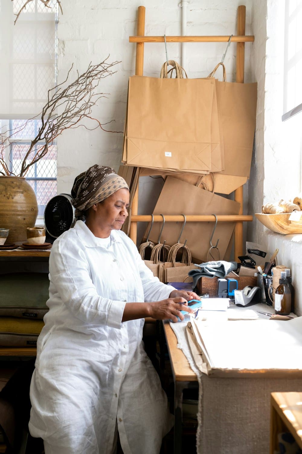 A maker at a workbench packing orders