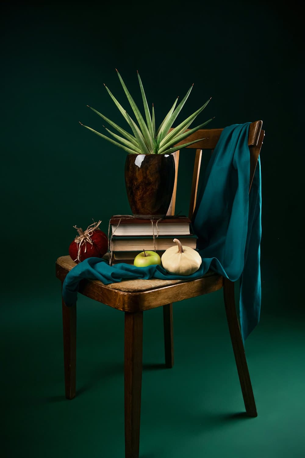 A hand-thrown stoneware planter on a wooden chair, photographed for a Woohl product listing